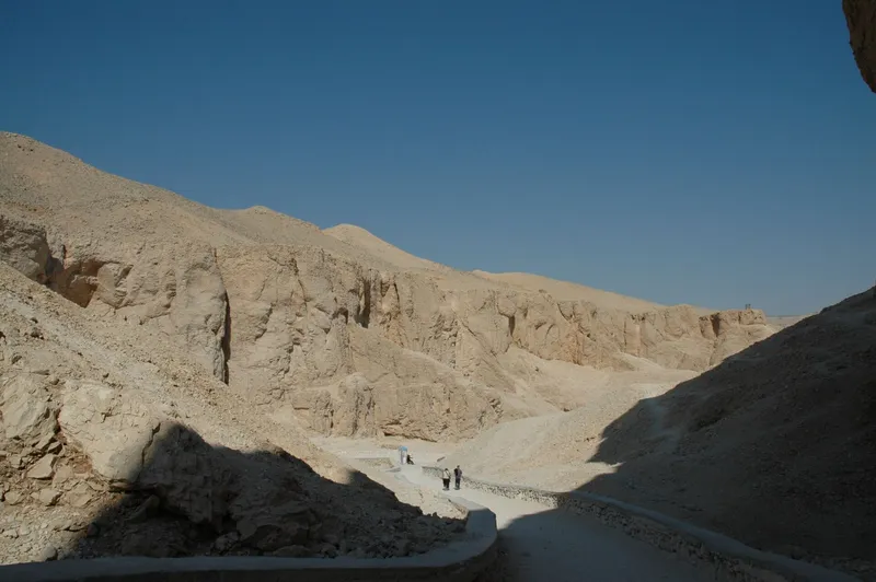 Path into the Valley of the Kings between pale limestone cliffs, half in shade