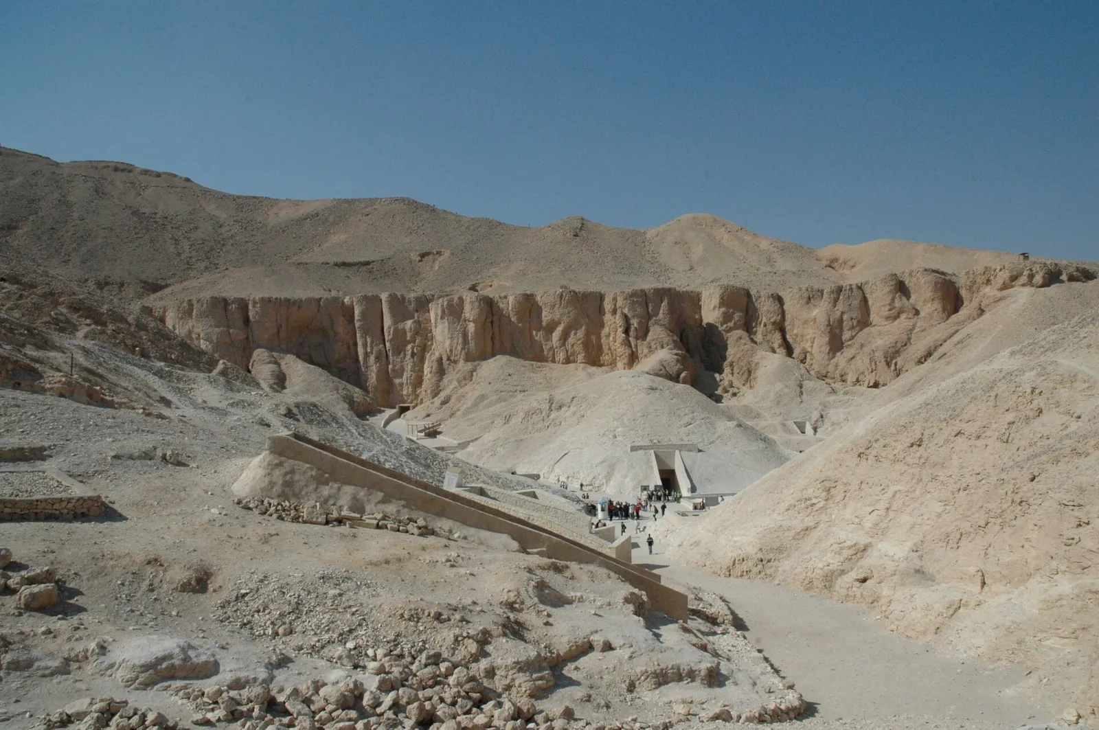View down the Valley of the Kings towards a tomb entrance under the cliffs