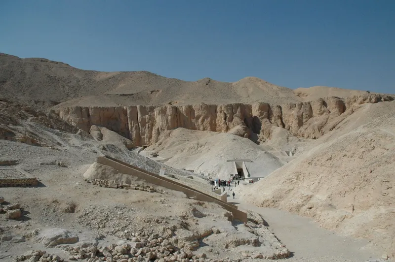 View down the Valley of the Kings towards a tomb entrance under the cliffs