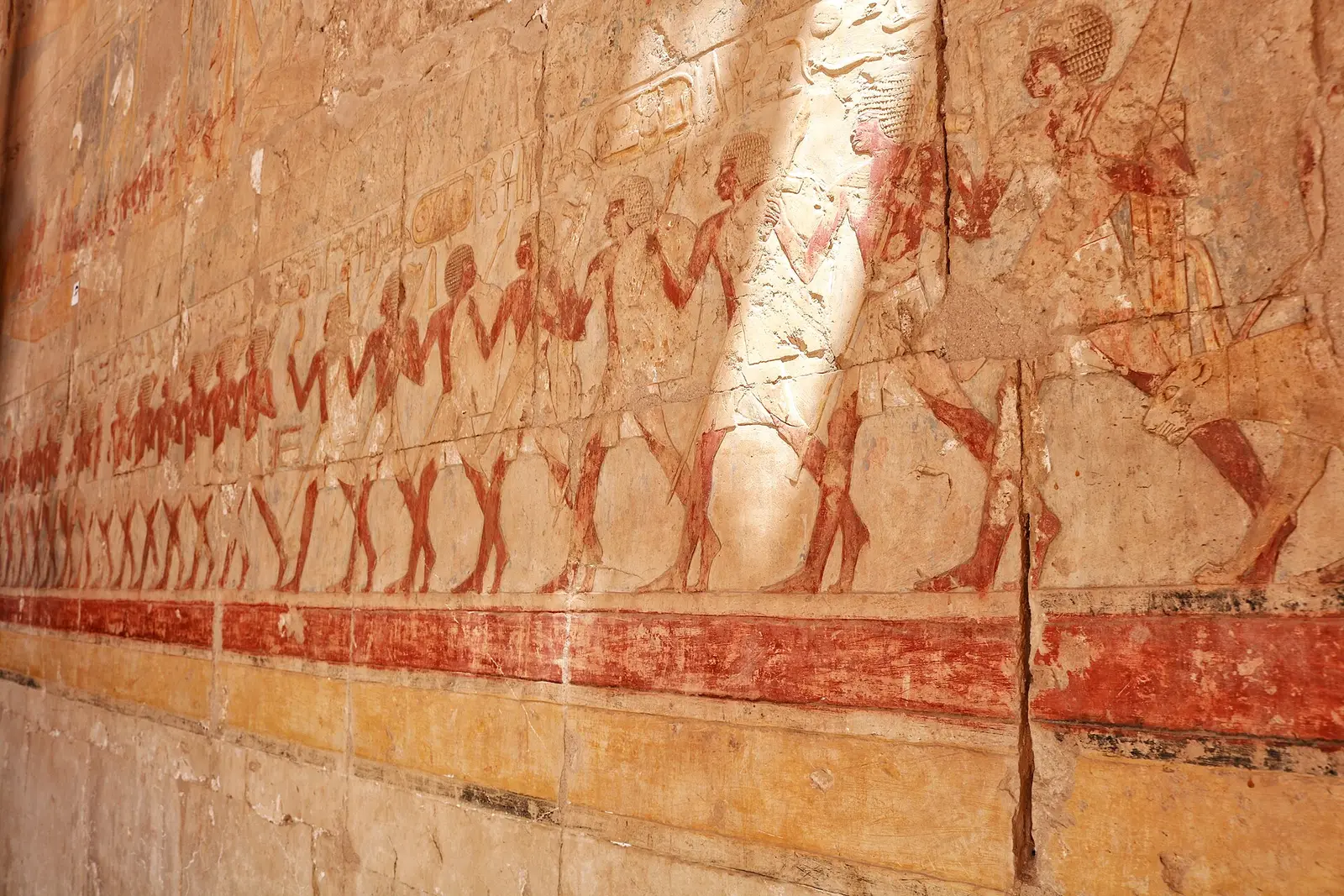 Painted relief of a long marching procession on a colonnade wall at Hatshepsut's temple