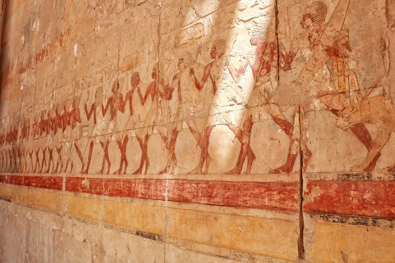 Painted relief of a long marching procession on a colonnade wall at Hatshepsut's temple