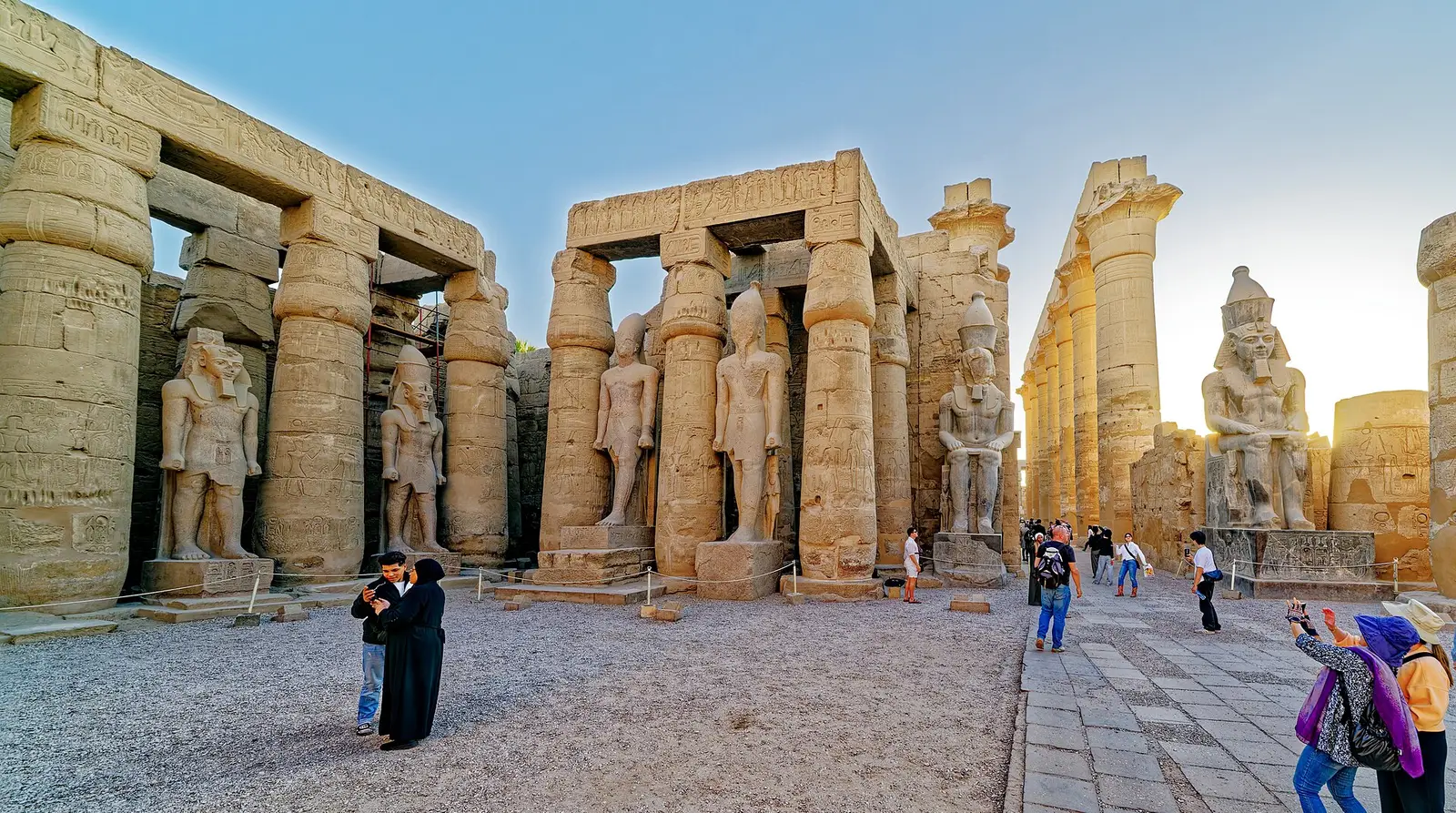 Standing statues of Ramesses II between the columns of the first court at Luxor Temple