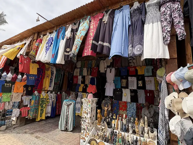 Souvenir shop with T-shirts, dresses and statuettes on display