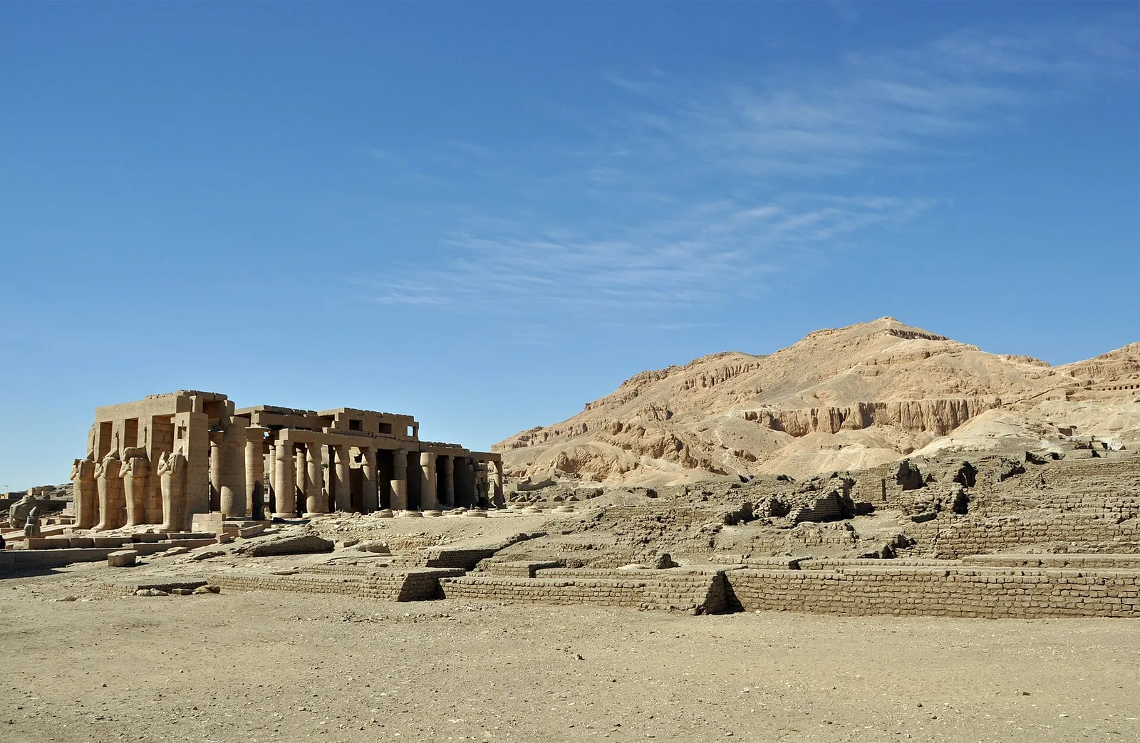 The Ramesseum's columns and pillars standing at the edge of the desert below the Theban hills