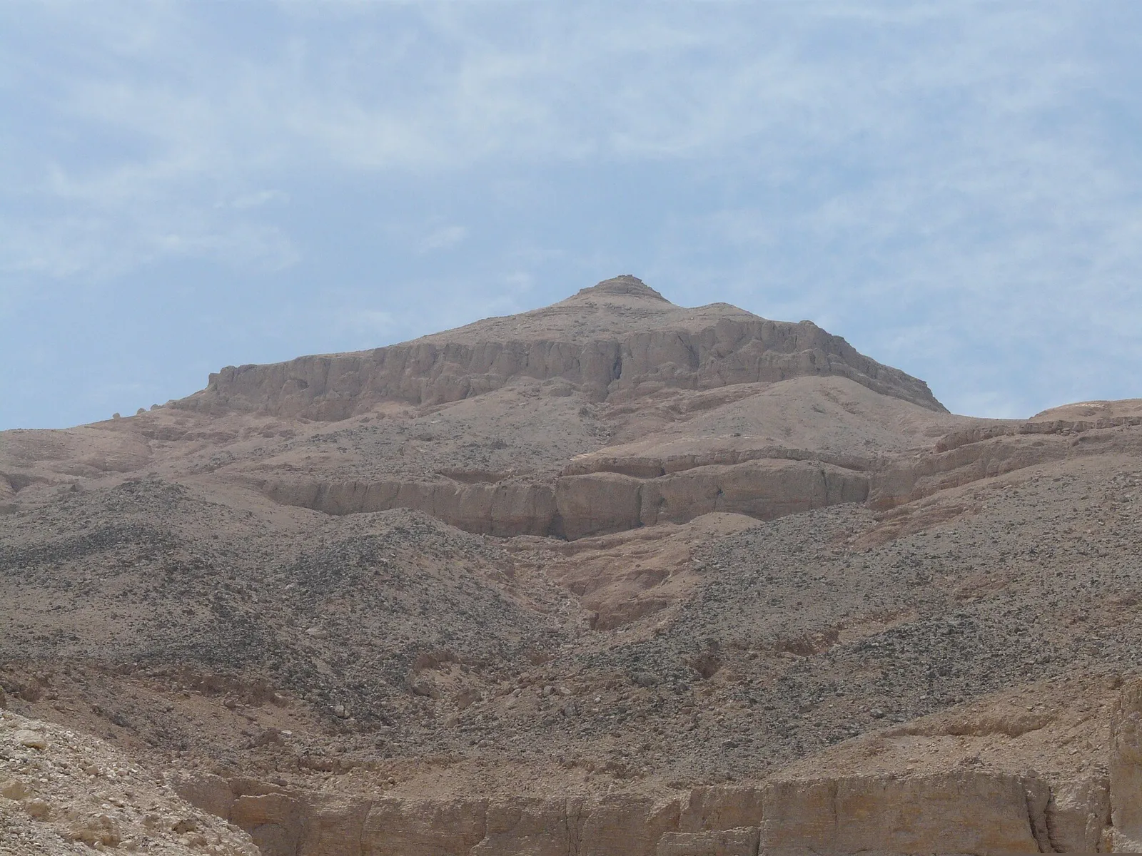The pyramid-shaped peak of al-Qurn above the valley