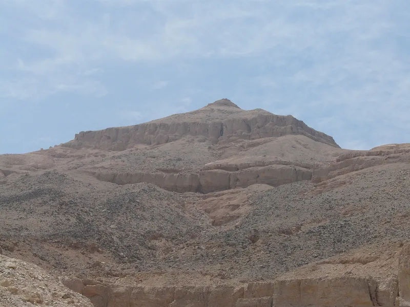 The pyramid-shaped peak of al-Qurn above the valley