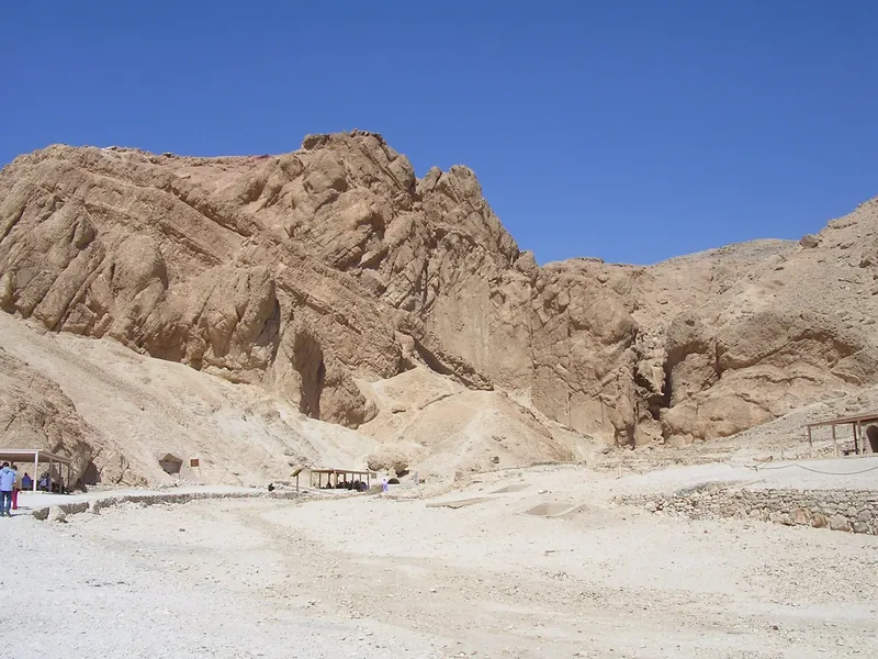 The rocky wadi of the Valley of the Queens, with shade shelters along the path