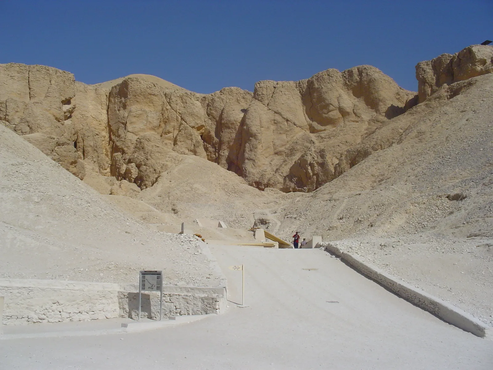 Paved main path leading into the Valley of the Kings between pale cliffs