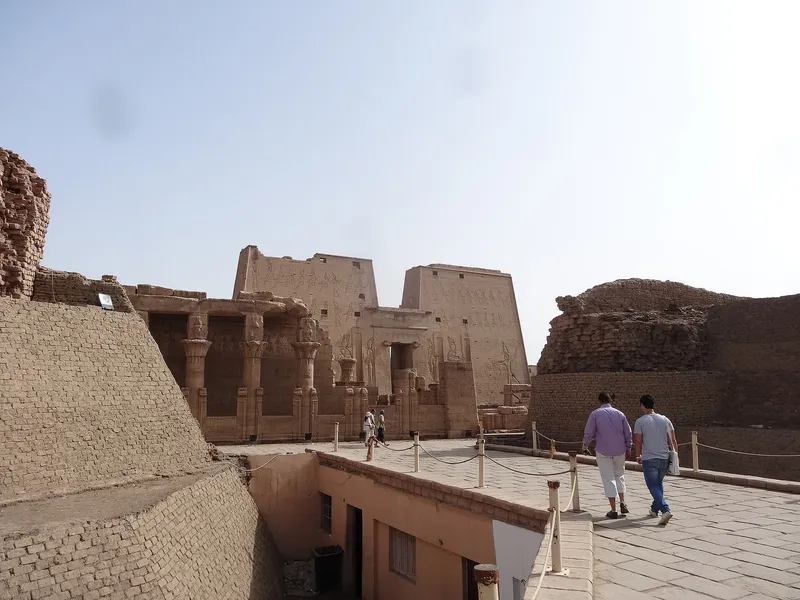 Edfu temple's carved pylon and the columned birth house seen from the walkway above the forecourt