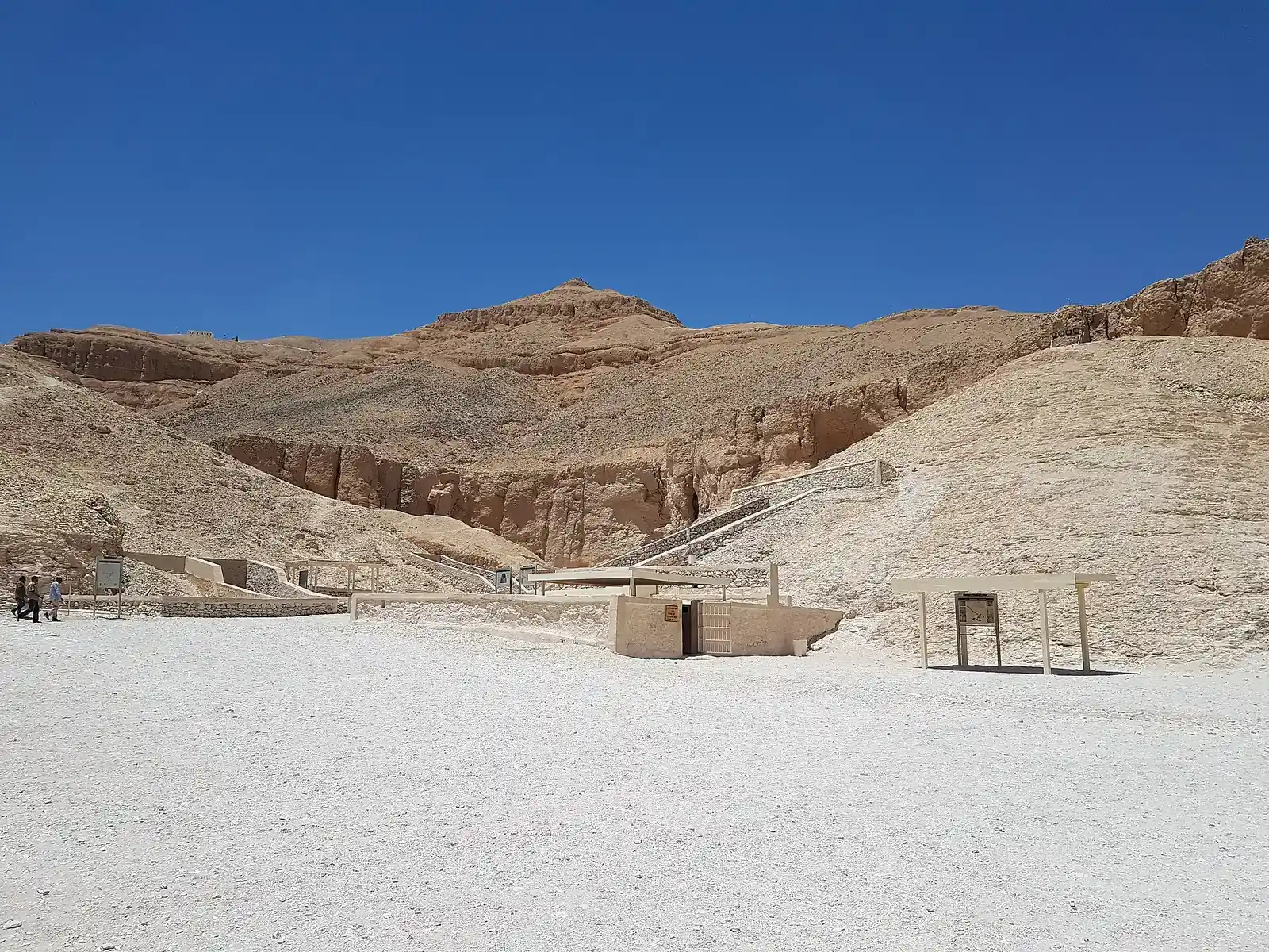 Wide view of the main wadi of the Valley of the Kings with tomb entrances below the cliffs