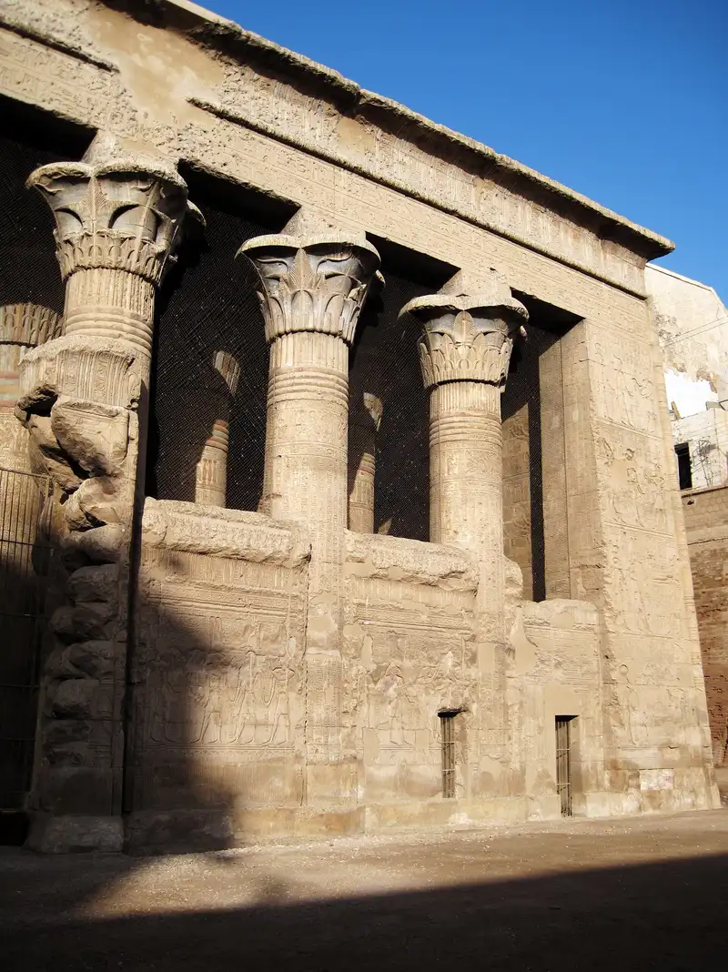 Carved floral capitals on the front columns of Esna temple, half in shadow